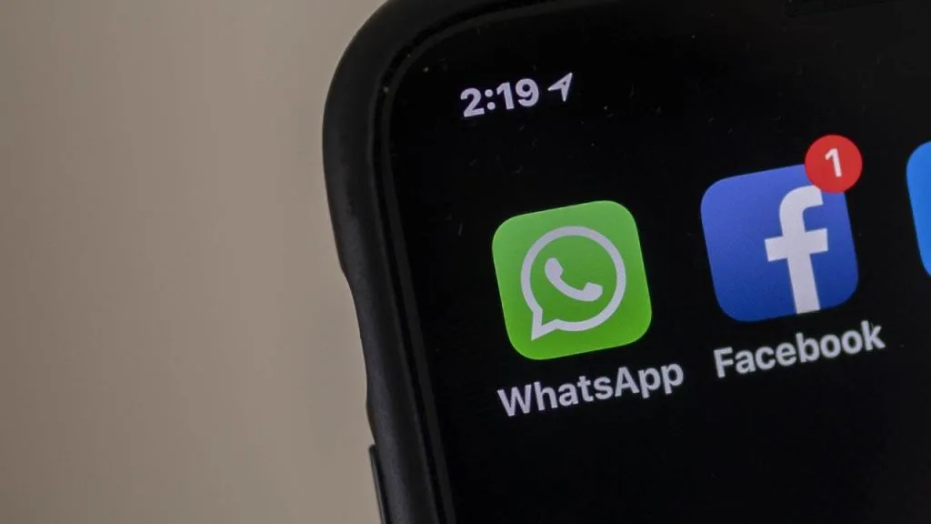 Close-up of a smartphone home screen showing WhatsApp and Facebook icons, symbolising the integration of WhatsApp ads across Meta platforms.