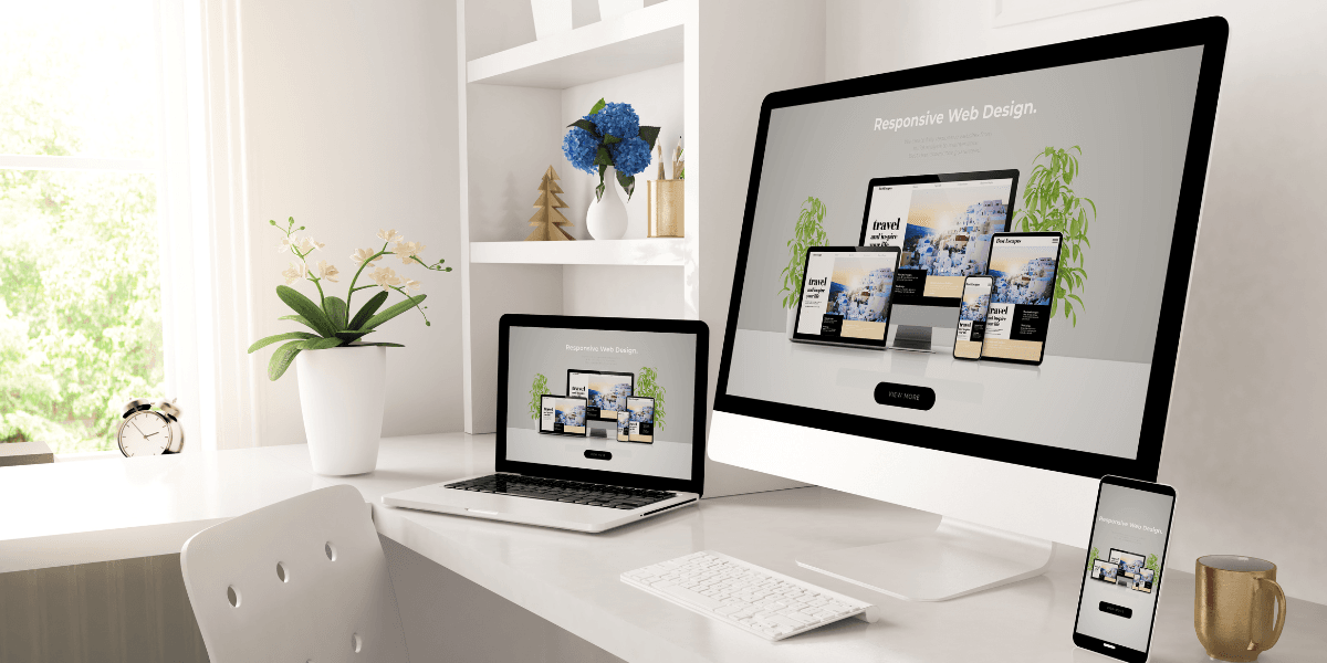 Practicing Sustainable Web Design across multiple devices on a clean white desk setup, showcasing responsive website layouts for desktop, laptop, tablet, and mobile screens — highlighting eco-friendly and efficient web design Gold Coast solutions.